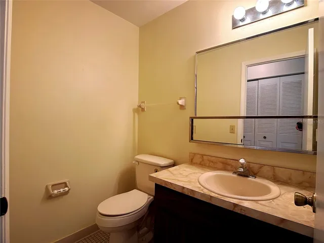 a bathroom with a sink a toilet and mirror