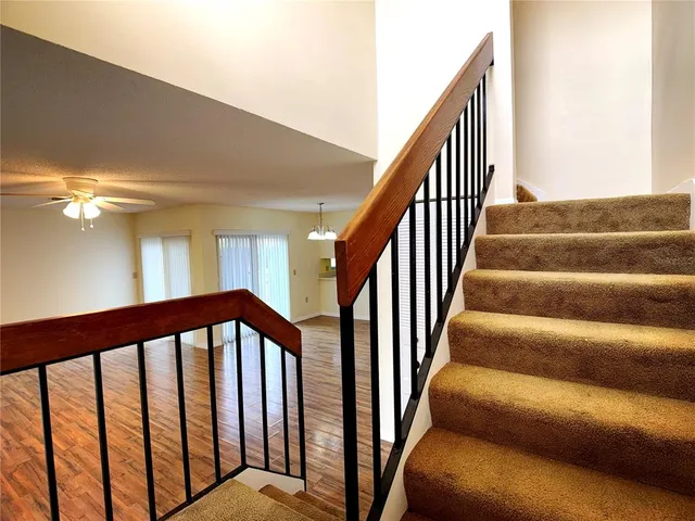a view of staircase with lots of frames on wall
