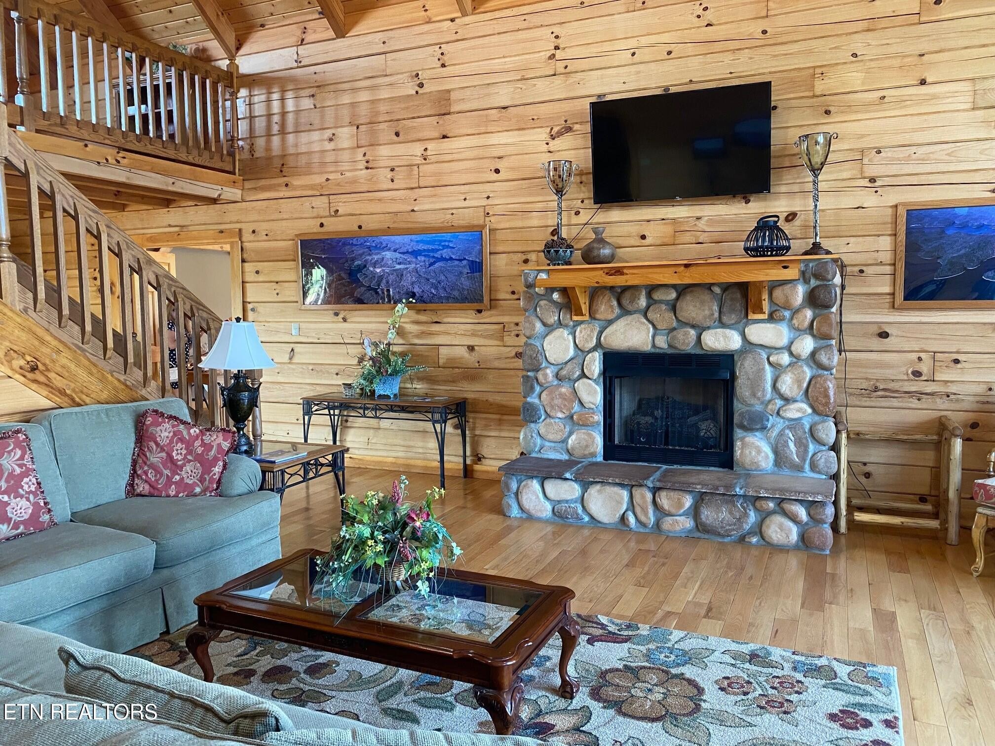 30 Bass Road Celina, TN 38551 - Photo 15 of 23 a living room with furniture a flat screen tv and a fireplace
