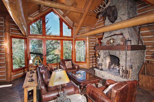 300 Horse Mountain Ranch Road Wolcott, CO 81655 - Photo 3 of 19 a living room with furniture a fireplace and a floor to ceiling window