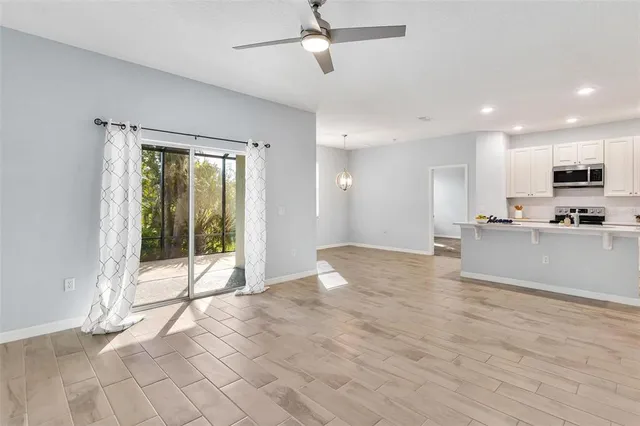 a view of kitchen with stainless steel appliances granite countertop cabinets and outdoor space