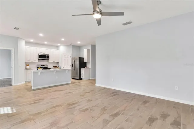 a view of kitchen with refrigerator microwave and stove