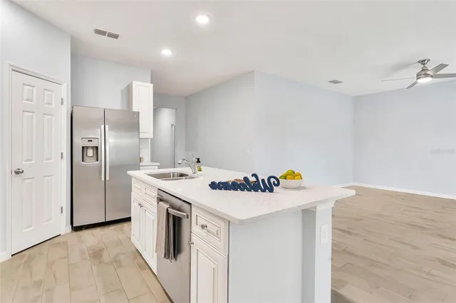 a kitchen that has a sink a refrigerator and a stove