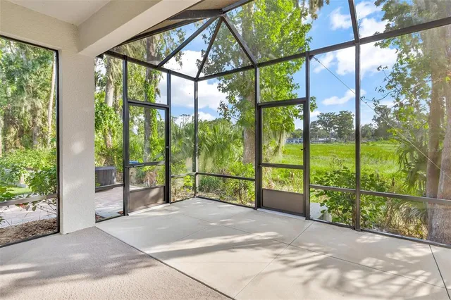 a view of porch with a floor to ceiling window and garden
