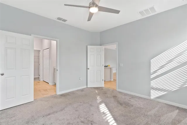 a view of empty room with ceiling fan