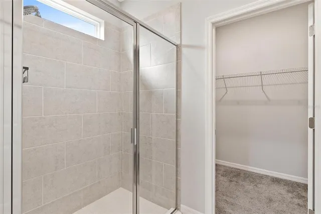 a bathroom with a glass shower door