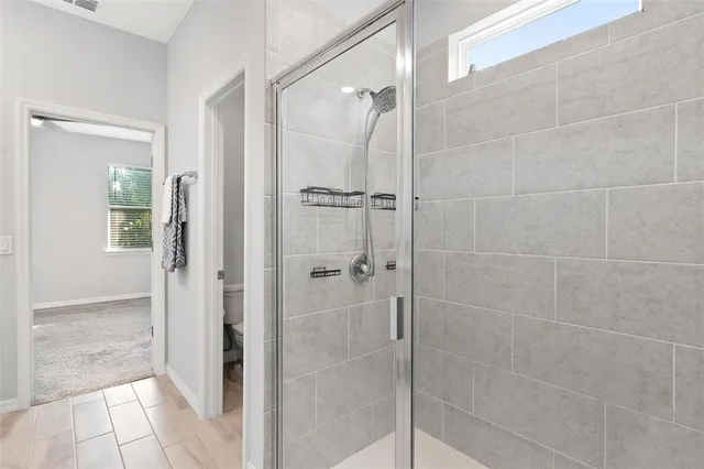 a bathroom with a glass shower door