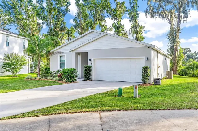 a front view of house with yard and green space