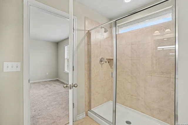 a bathroom with a glass shower door