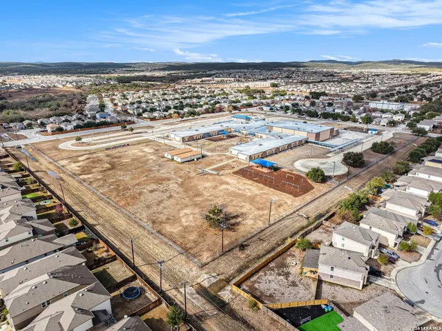 an aerial view of residential houses with outdoor space