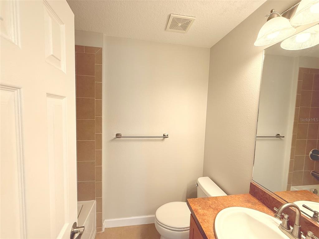 7350 Black Walnut Way Lakewood Ranch, FL 34202 - Photo 32 of 52 a white toilet sitting next to a bathroom sink and a shower