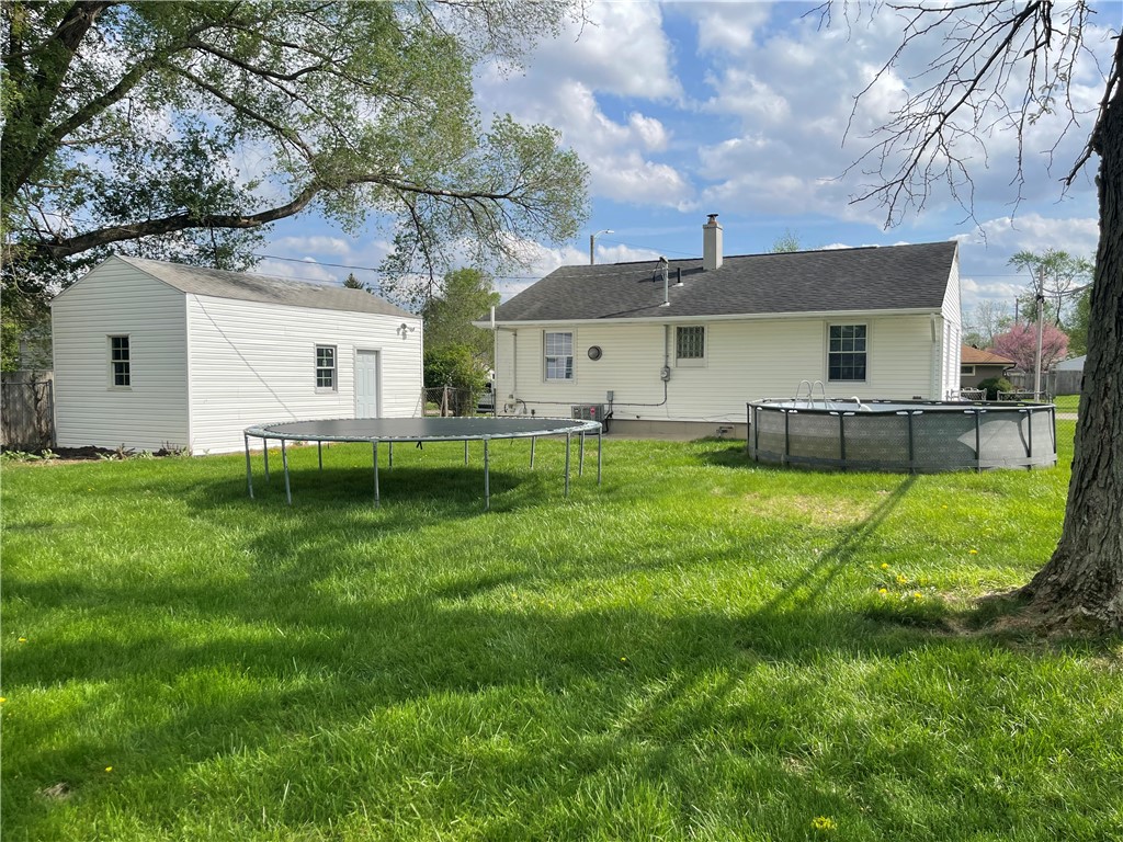 1361 Sussex Road Troy, OH 45373 - Photo 13 of 25 This verdant yard offers ample space for recreation and relaxation, complemented by practical outbuildings.