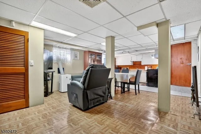 a living room with furniture a dining table and chairs in it