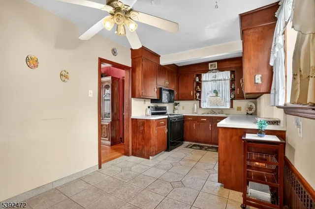 a kitchen with a refrigerator a stove top oven a sink and dishwasher