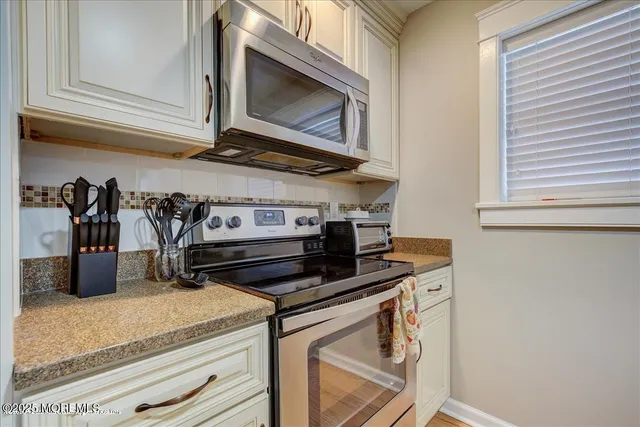a kitchen with stainless steel appliances granite countertop a sink and cabinets