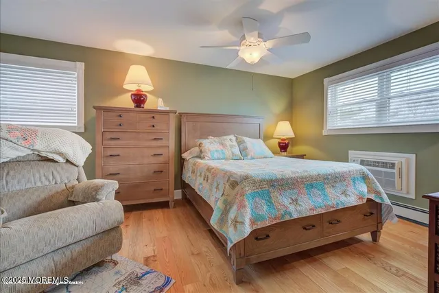 a spacious bedroom with a bed and a chandelier