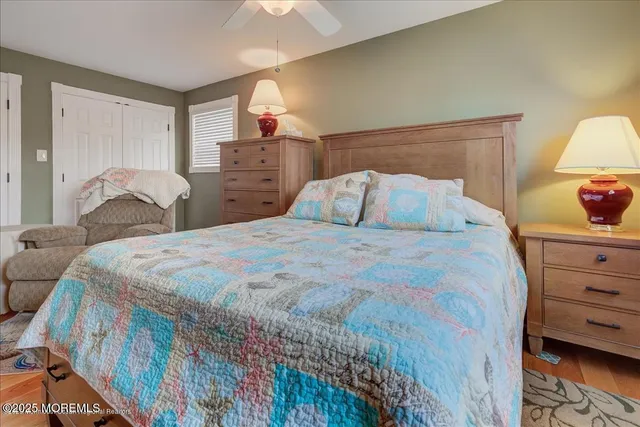 a bedroom with a bed and dresser with mirror