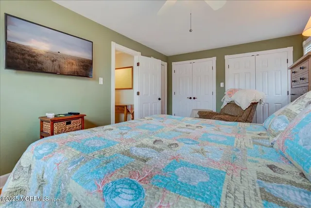 a bedroom with a bed and painting on the wall