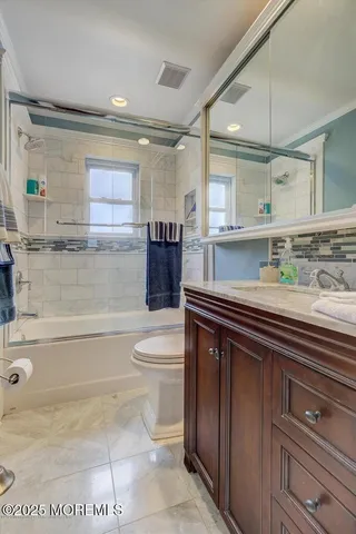 a bathroom with a sink a toilet and bathtub