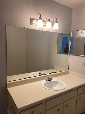 a bathroom with a sink and a mirror