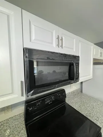 a stove top oven sitting inside of a kitchen