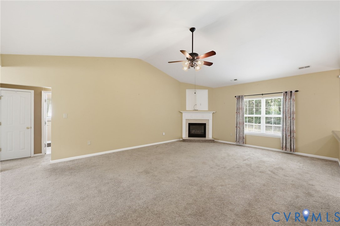 14719 Clover Ridge Lane Chesterfield, VA 23832 - Photo 9 of 36 Spacious living area featuring a vaulted ceiling w