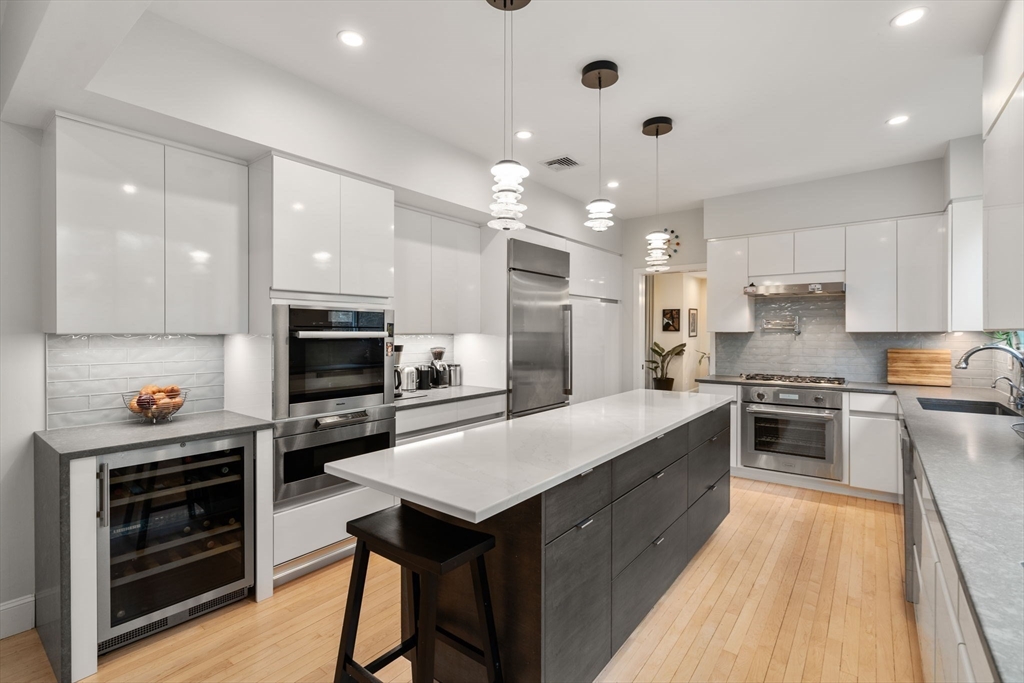 202 Allandale Road, Unit B Boston, MA 02467 - Photo 12 of 39 a large kitchen with kitchen island a stove a sink a refrigerator and a microwave