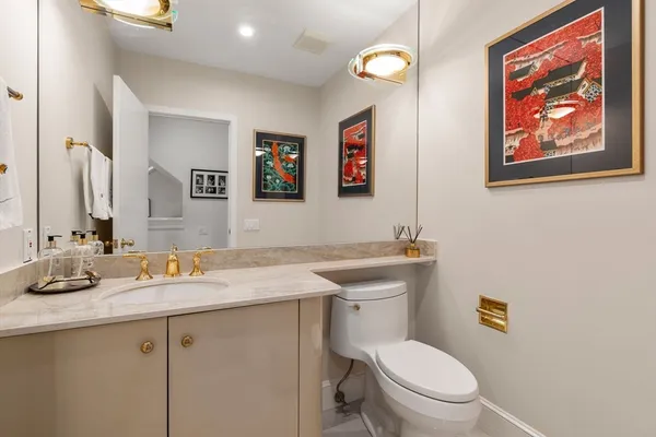 a bathroom with a toilet a sink and mirror