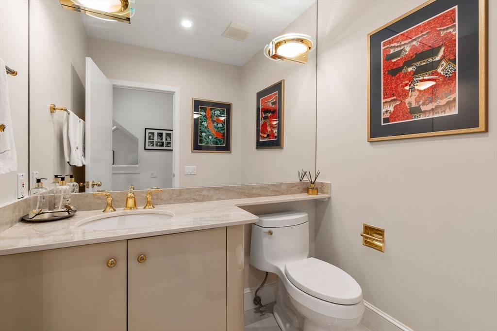 202 Allandale Road, Unit B Boston, MA 02467 - Photo 14 of 39 a bathroom with a toilet a sink and mirror