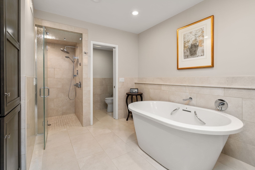 202 Allandale Road, Unit B Boston, MA 02467 - Photo 17 of 39 a bathroom with a bathtub and a shower