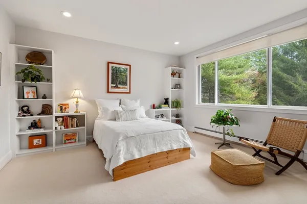 a spacious bedroom with a bed and a couch