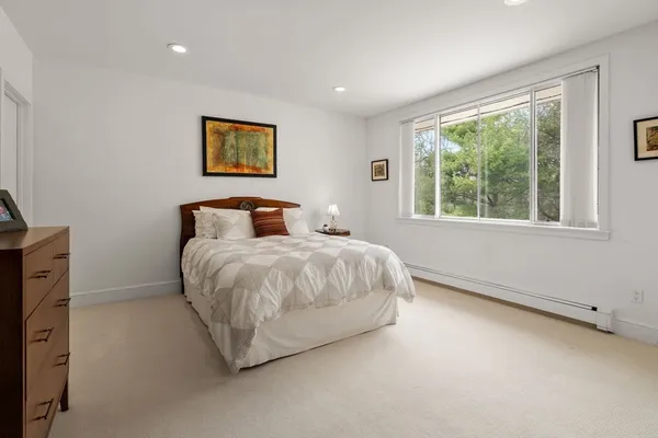 a bedroom with a large bed and a window