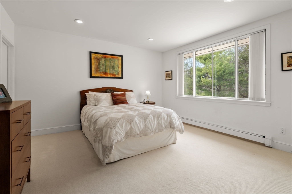 202 Allandale Road, Unit B Boston, MA 02467 - Photo 23 of 39 a bedroom with a large bed and a window