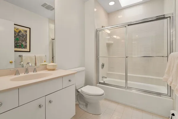 a bathroom with a toilet a sink and a mirror