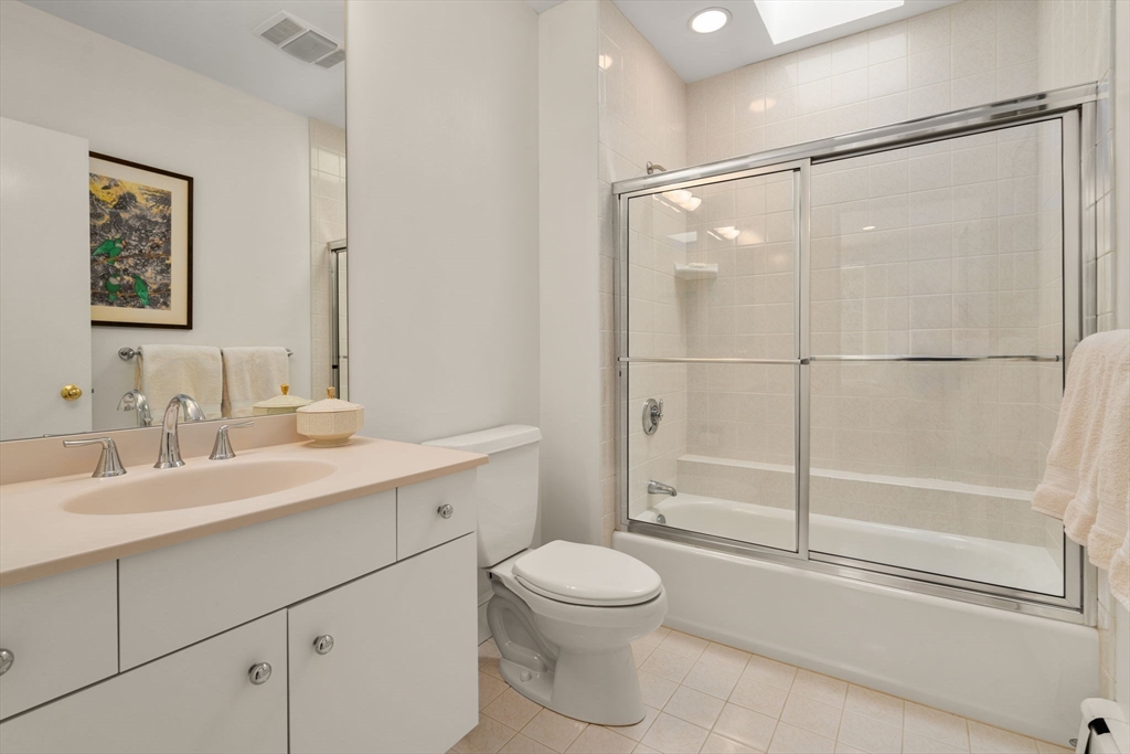 202 Allandale Road, Unit B Boston, MA 02467 - Photo 24 of 39 a bathroom with a toilet a sink and a mirror