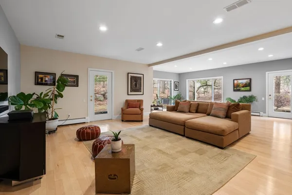 a living room with furniture and a potted plant