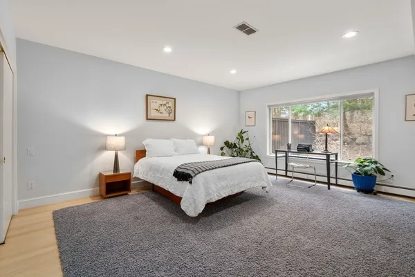a spacious bedroom with a bed and a couch