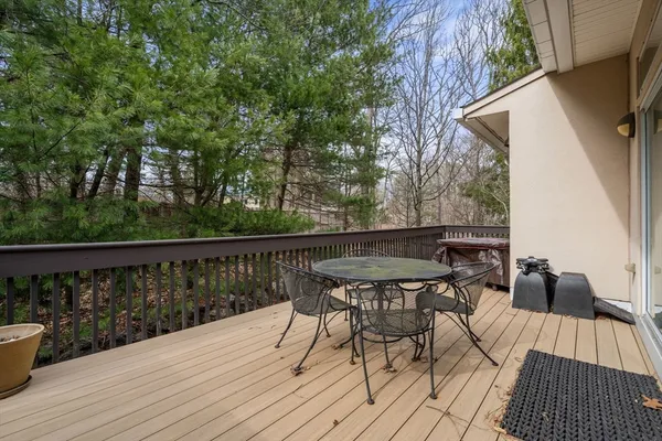 a view of balcony with wooden floor and outdoor seating