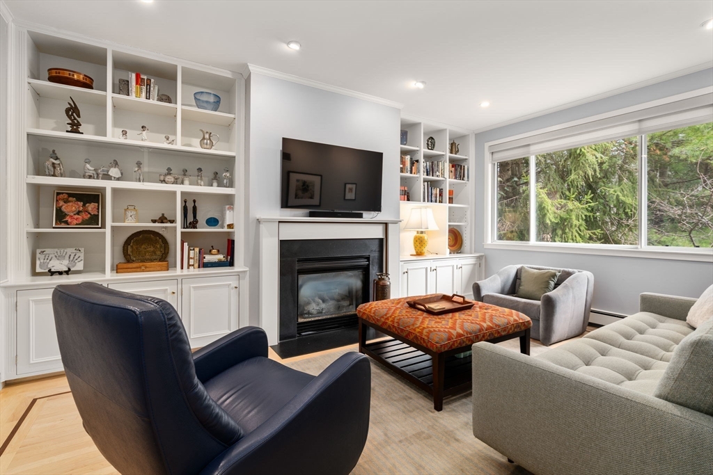 202 Allandale Road, Unit B Boston, MA 02467 - Photo 3 of 39 a living room with furniture a flat screen tv and a fireplace