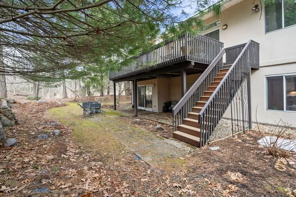 a view of backyard with deck and outdoor seating