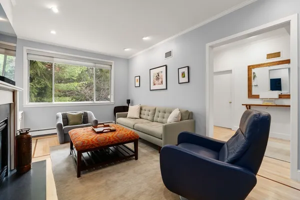 a living room with furniture a large window and a flat screen tv