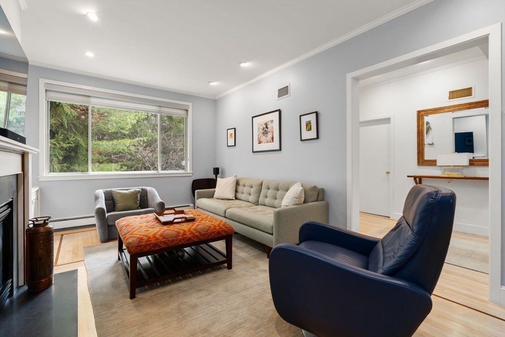 202 Allandale Road, Unit B Boston, MA 02467 - Photo 4 of 39 a living room with furniture a large window and a flat screen tv