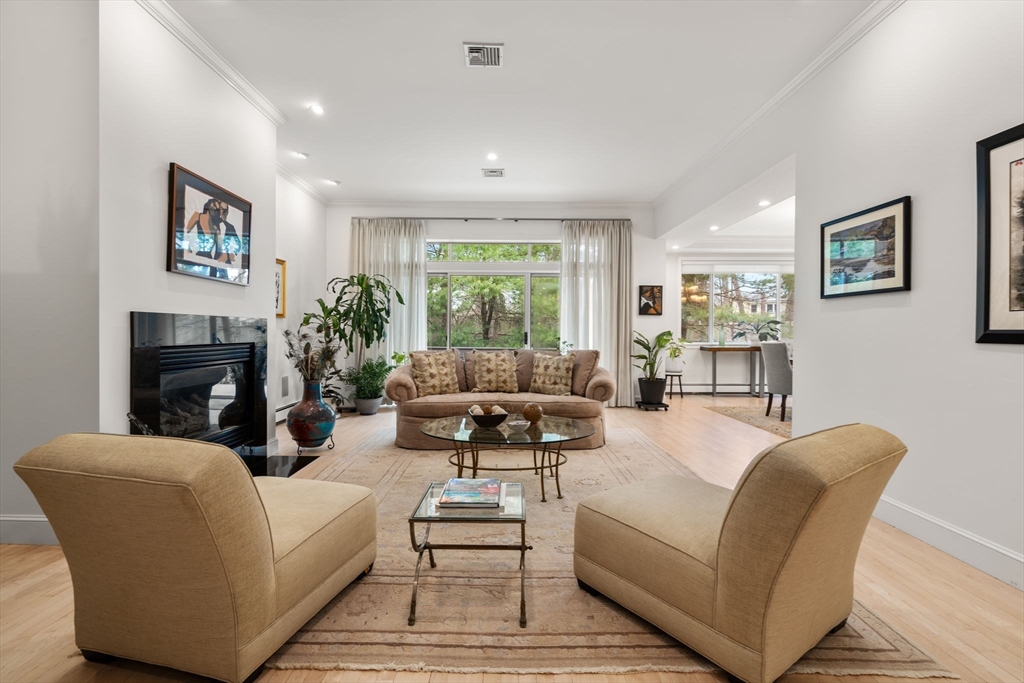 202 Allandale Road, Unit B Boston, MA 02467 - Photo 6 of 39 a living room with furniture and a fireplace