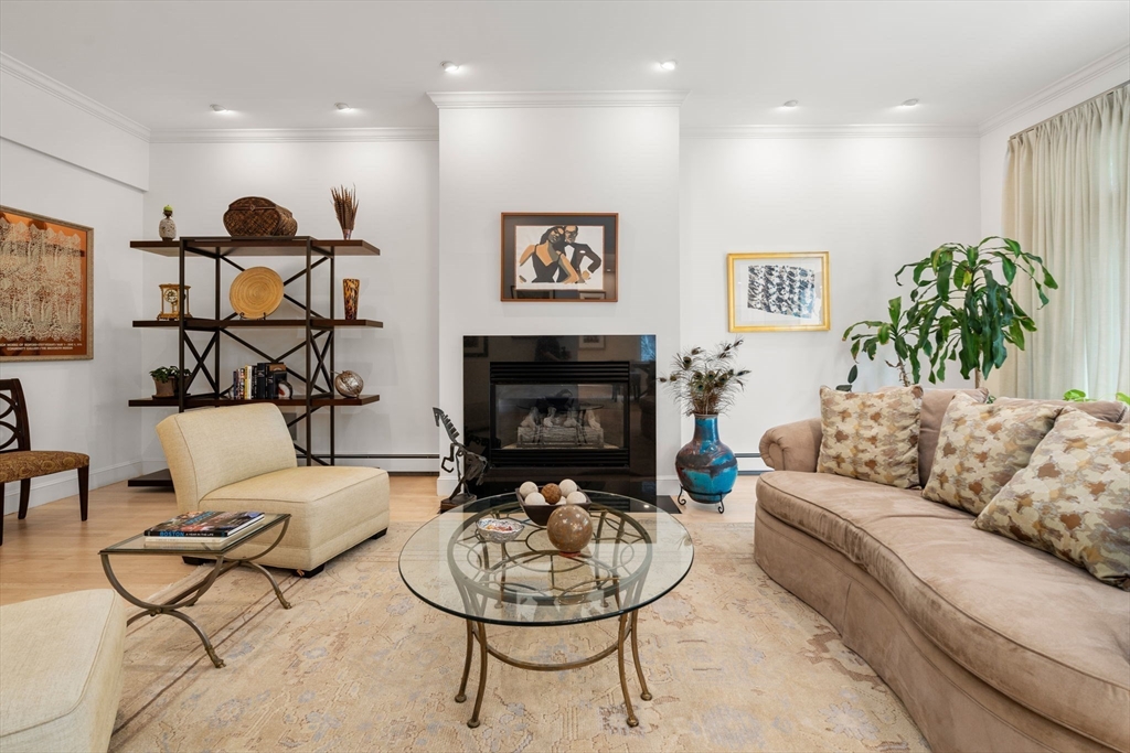202 Allandale Road, Unit B Boston, MA 02467 - Photo 7 of 39 a living room with furniture and a fireplace