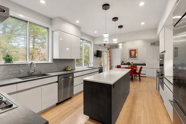 a kitchen with stainless steel appliances a sink stove and cabinets