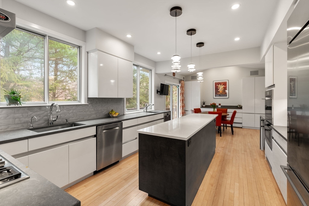 202 Allandale Road, Unit B Boston, MA 02467 - Photo 10 of 39 a kitchen with stainless steel appliances a sink stove and cabinets