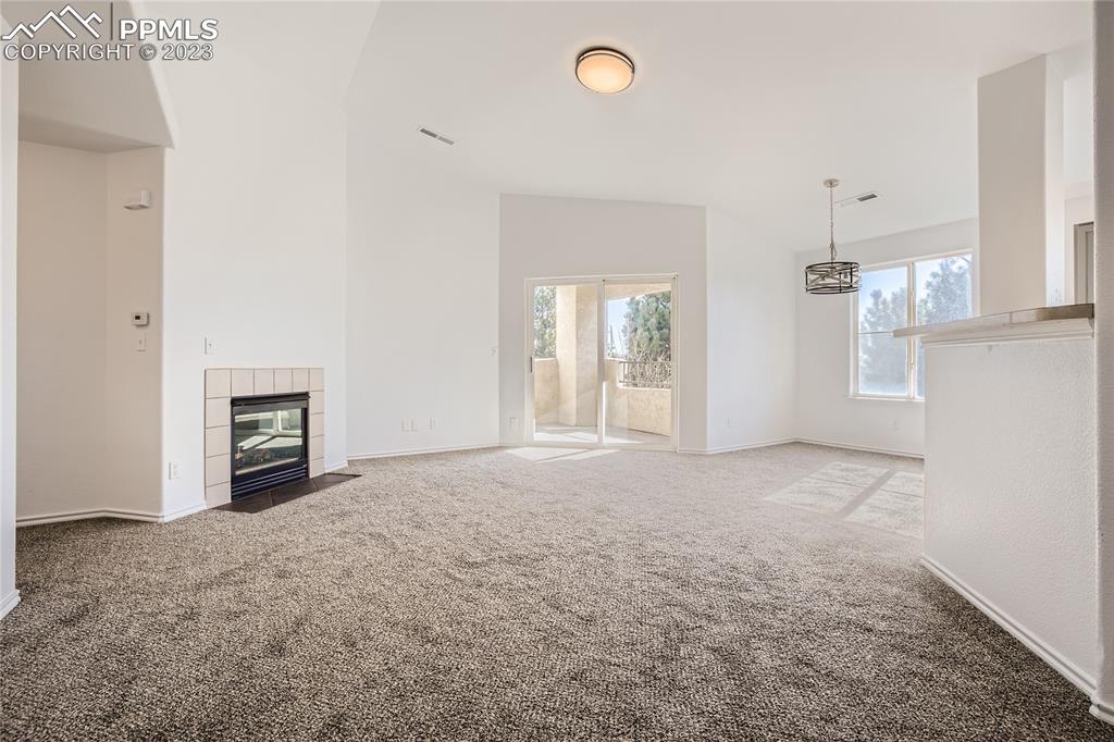 3764 Riviera Grove, Unit 203 Colorado Springs, CO 80922 - Photo 15 of 31 an empty room with windows and fireplace