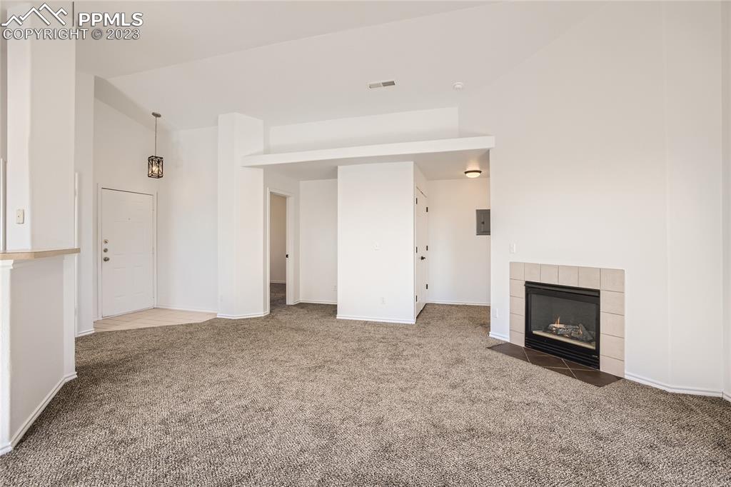 3764 Riviera Grove, Unit 203 Colorado Springs, CO 80922 - Photo 17 of 31 an empty room with a fireplace and a window