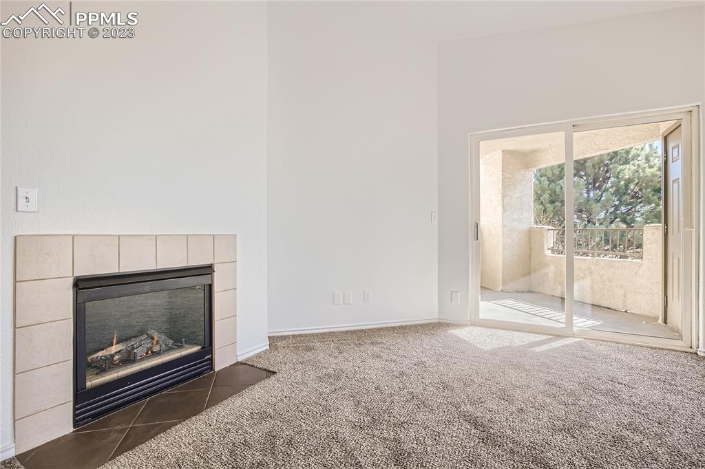 3764 Riviera Grove, Unit 203 Colorado Springs, CO 80922 - Photo 24 of 31 a view of an empty room with a fireplace