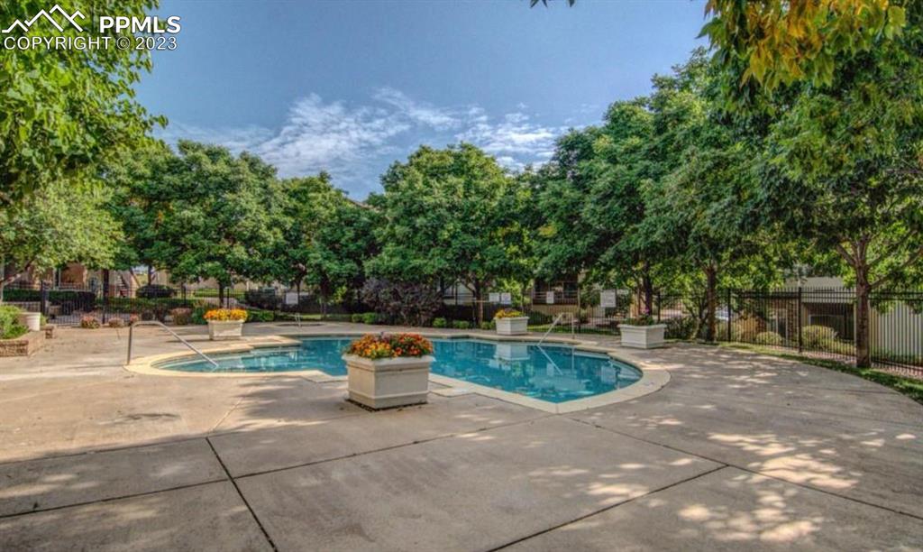 3764 Riviera Grove, Unit 203 Colorado Springs, CO 80922 - Photo 30 of 31 a view of a swimming pool with a patio